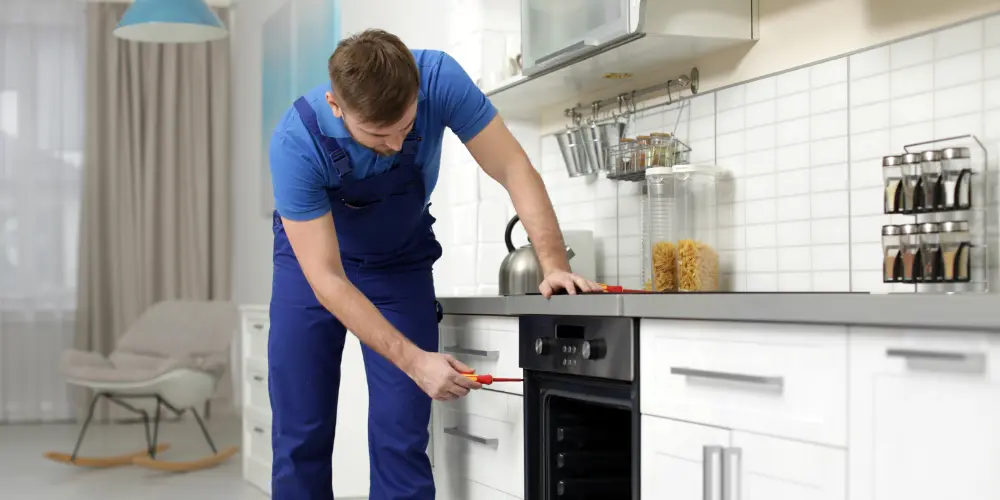 Technician repairing a dishwasher