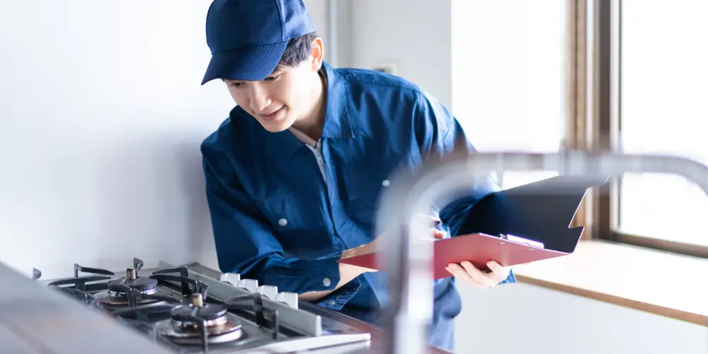 Technician inspecting a gas stove